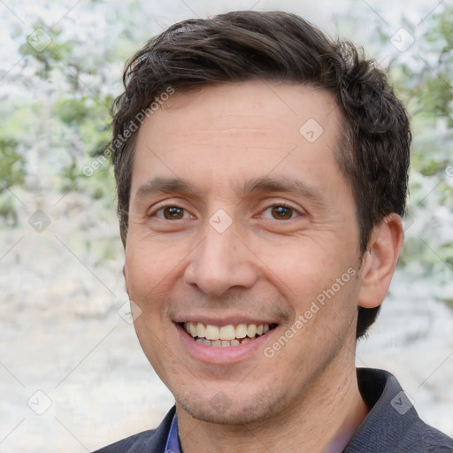 Joyful white adult male with short  brown hair and brown eyes