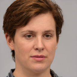 Joyful white adult female with short  brown hair and grey eyes