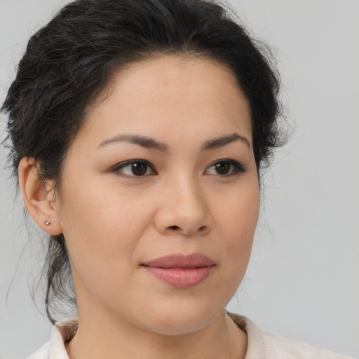 Joyful latino young-adult female with medium  brown hair and brown eyes