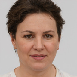 Joyful white adult female with short  brown hair and brown eyes