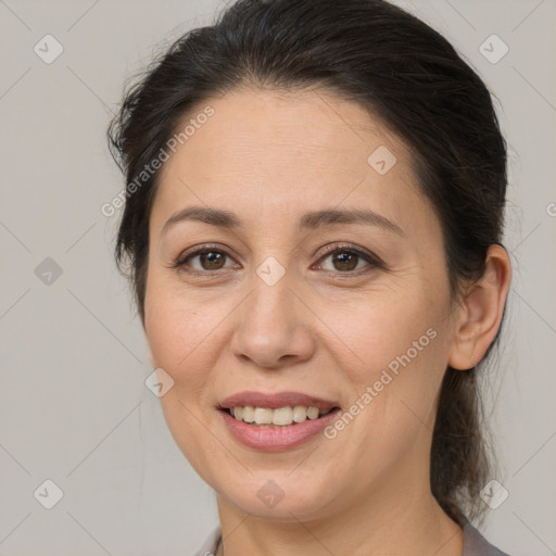 Joyful white adult female with medium  brown hair and brown eyes