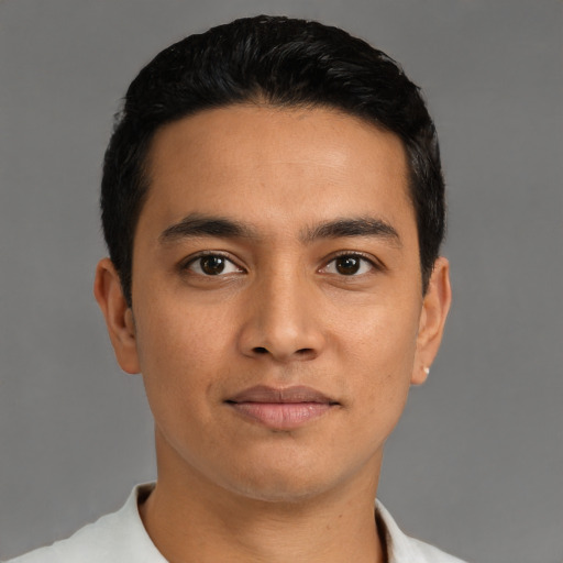 Joyful latino young-adult male with short  black hair and brown eyes