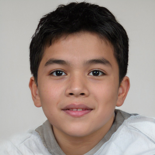 Joyful asian child male with short  brown hair and brown eyes
