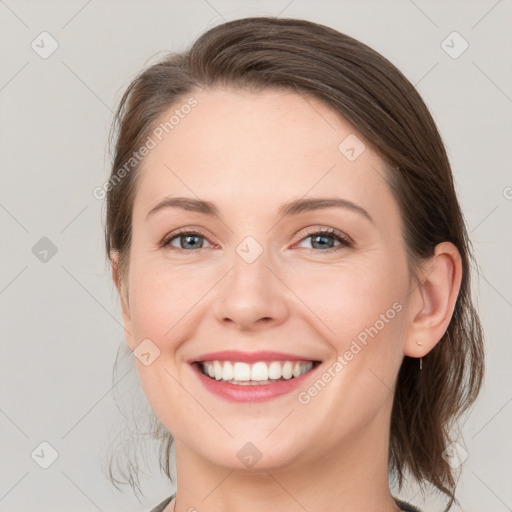 Joyful white young-adult female with medium  brown hair and grey eyes