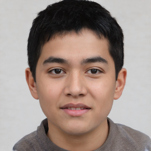 Joyful asian child male with short  black hair and brown eyes