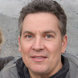 Joyful white adult male with short  brown hair and grey eyes