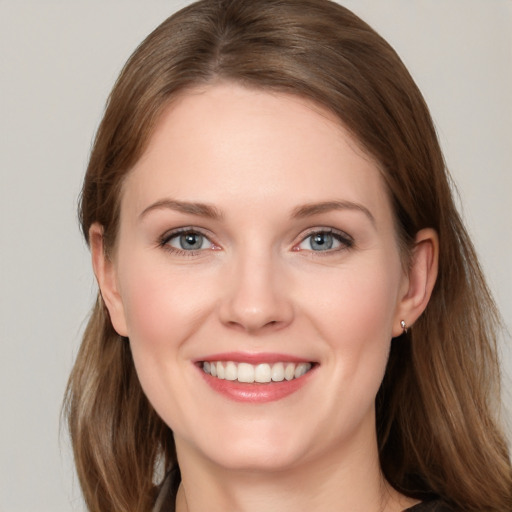 Joyful white young-adult female with long  brown hair and grey eyes