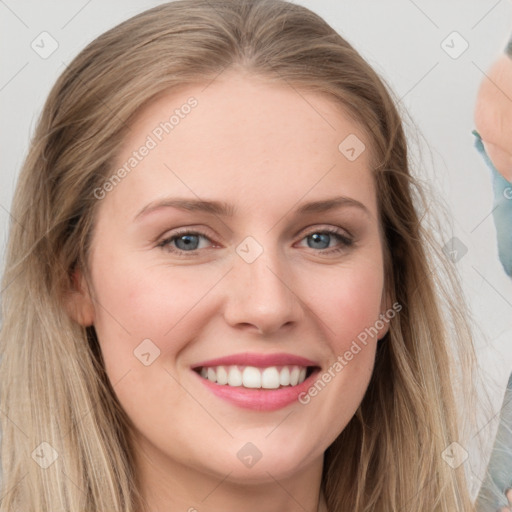 Joyful white young-adult female with long  brown hair and blue eyes