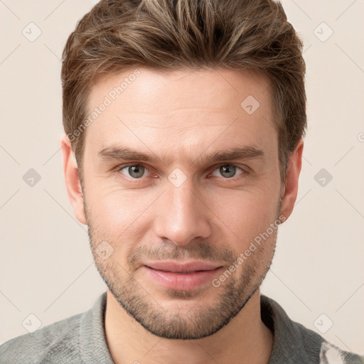 Joyful white young-adult male with short  brown hair and grey eyes