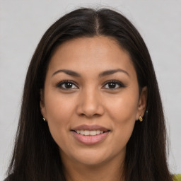 Joyful latino young-adult female with long  brown hair and brown eyes