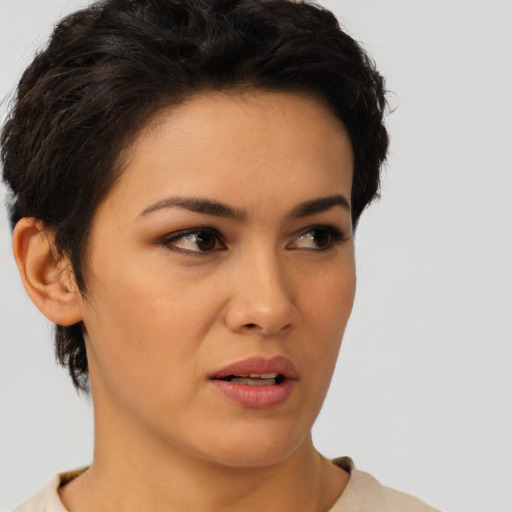 Joyful latino young-adult female with short  brown hair and brown eyes