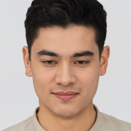 Joyful asian young-adult male with short  brown hair and brown eyes