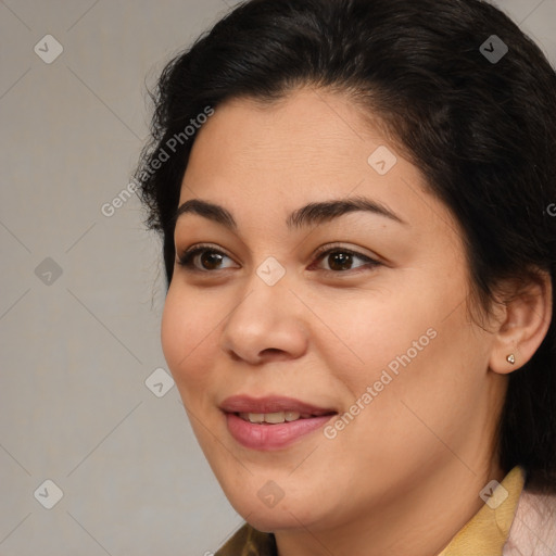 Joyful latino young-adult female with medium  brown hair and brown eyes