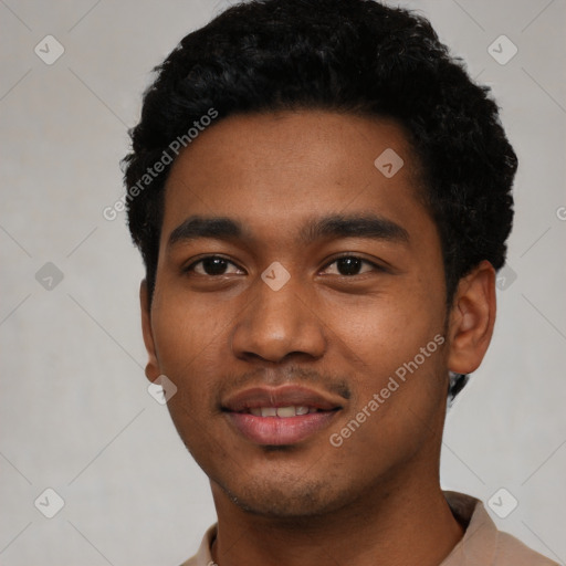 Joyful black young-adult male with short  black hair and brown eyes