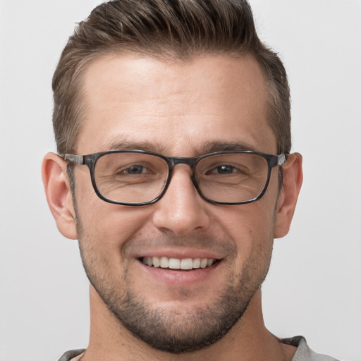 Joyful white adult male with short  brown hair and grey eyes