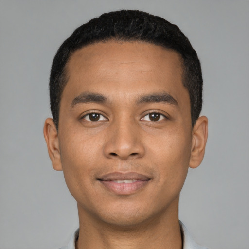 Joyful latino young-adult male with short  black hair and brown eyes