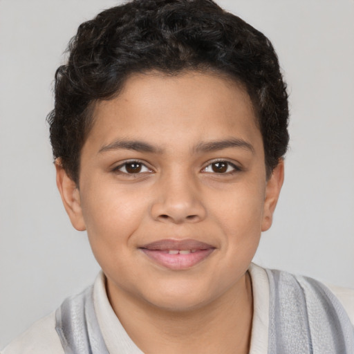 Joyful latino child male with short  brown hair and brown eyes