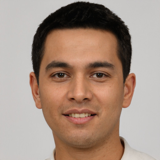 Joyful white young-adult male with short  black hair and brown eyes