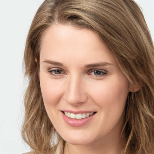 Joyful white young-adult female with long  brown hair and grey eyes