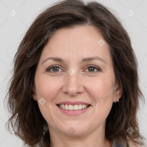 Joyful white adult female with long  brown hair and brown eyes