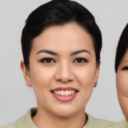 Joyful asian young-adult female with medium  brown hair and brown eyes