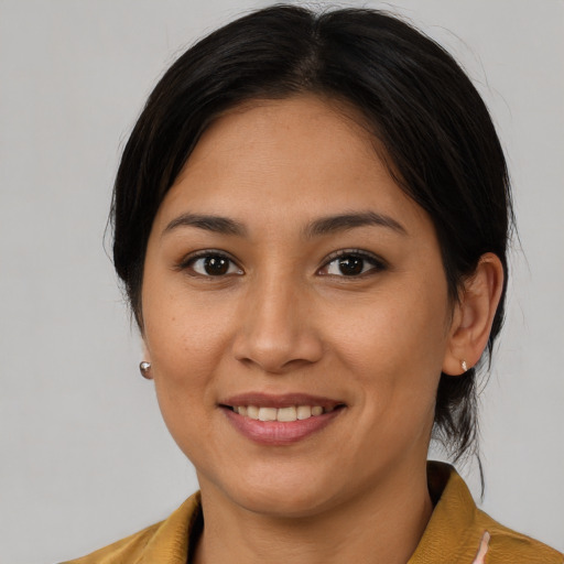 Joyful latino young-adult female with medium  brown hair and brown eyes