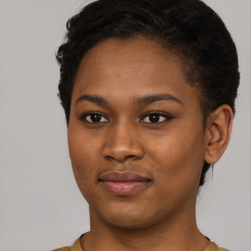 Joyful black young-adult female with short  brown hair and brown eyes