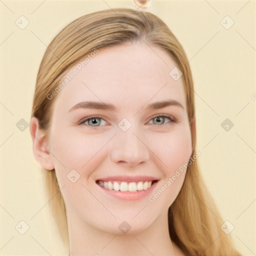 Joyful white young-adult female with long  brown hair and blue eyes