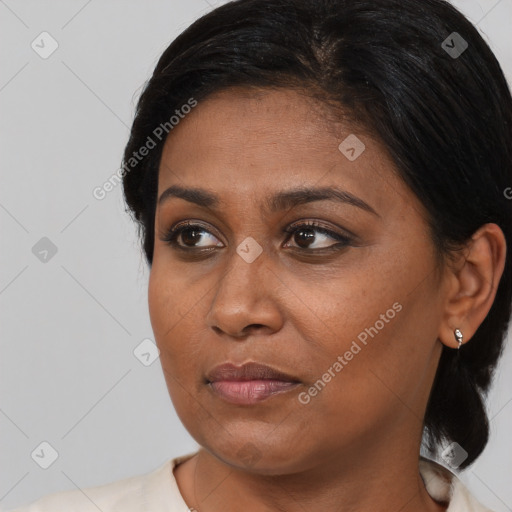 Joyful black young-adult female with medium  brown hair and brown eyes