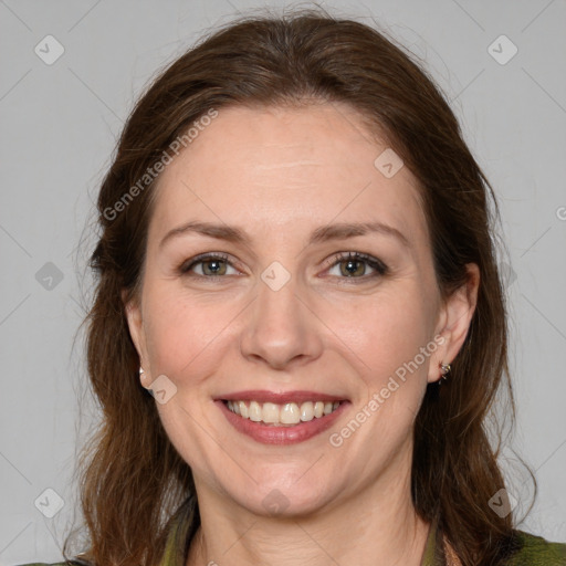 Joyful white adult female with medium  brown hair and green eyes