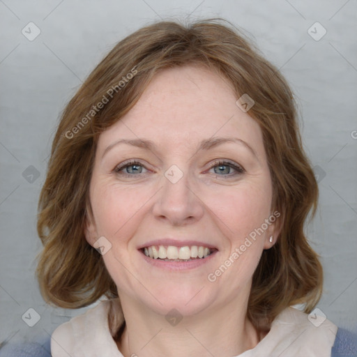 Joyful white adult female with medium  brown hair and blue eyes