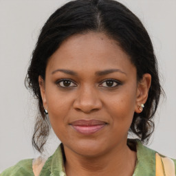 Joyful black young-adult female with medium  brown hair and brown eyes