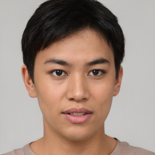 Joyful asian young-adult female with short  black hair and brown eyes