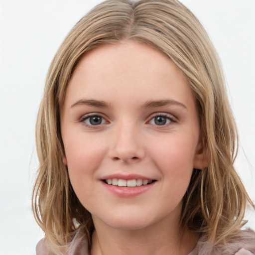 Joyful white child female with medium  brown hair and brown eyes