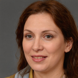 Joyful white adult female with long  brown hair and brown eyes