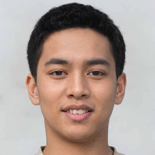 Joyful asian young-adult male with short  black hair and brown eyes