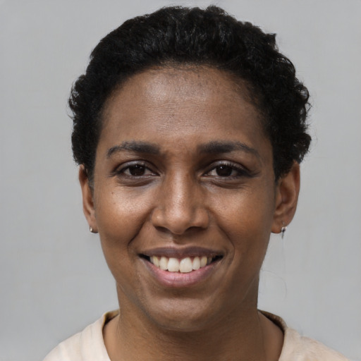 Joyful latino young-adult female with short  black hair and brown eyes