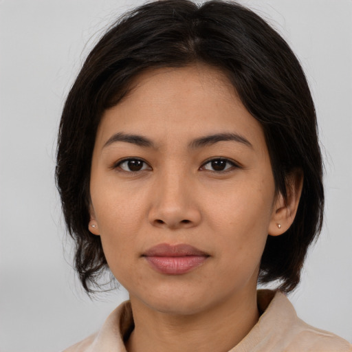 Joyful asian young-adult female with medium  brown hair and brown eyes