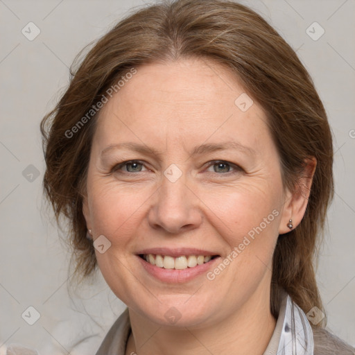 Joyful white adult female with medium  brown hair and grey eyes