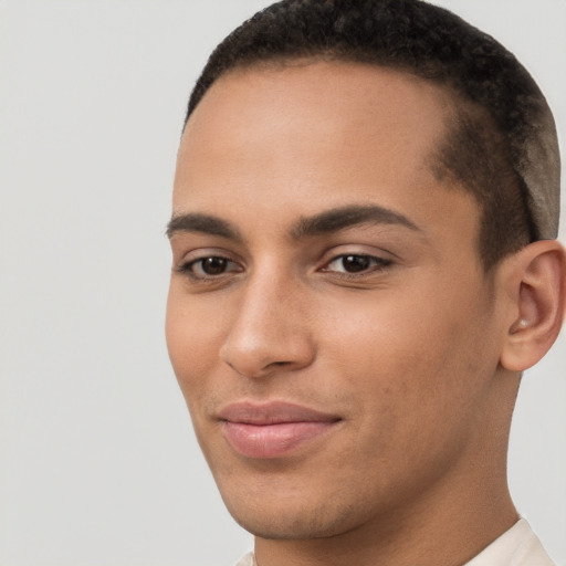 Joyful latino young-adult male with short  brown hair and brown eyes