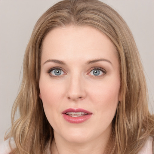 Joyful white young-adult female with long  brown hair and blue eyes