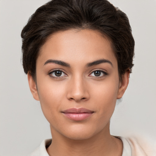 Joyful white young-adult female with short  brown hair and brown eyes