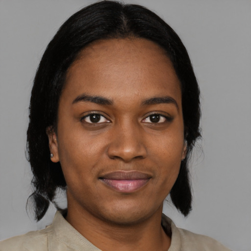 Joyful black young-adult female with medium  black hair and brown eyes