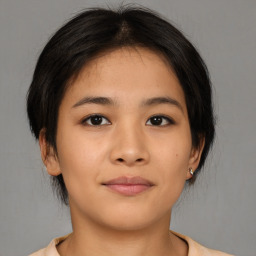 Joyful asian young-adult female with medium  brown hair and brown eyes