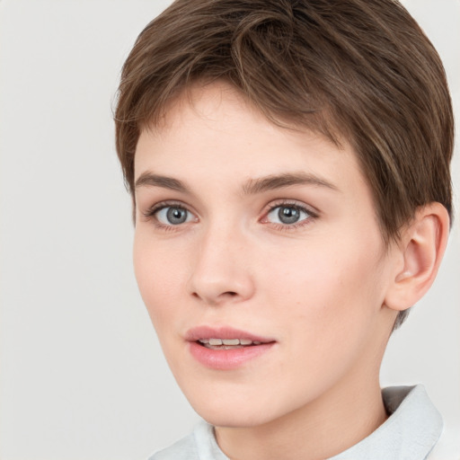 Joyful white young-adult female with short  brown hair and grey eyes