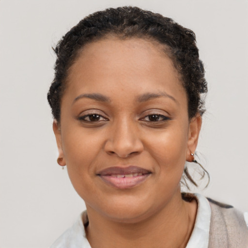 Joyful black young-adult female with short  black hair and brown eyes