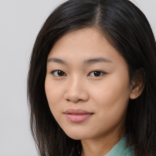 Joyful asian young-adult female with long  brown hair and brown eyes