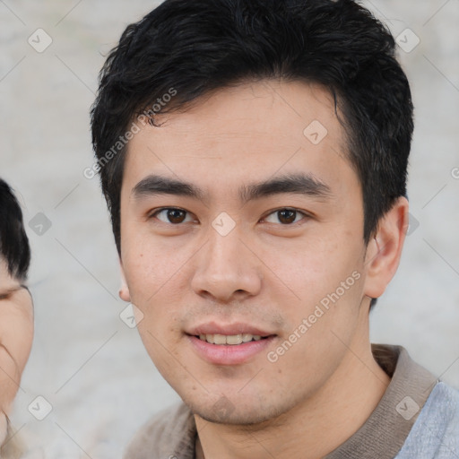 Joyful asian young-adult male with short  black hair and brown eyes