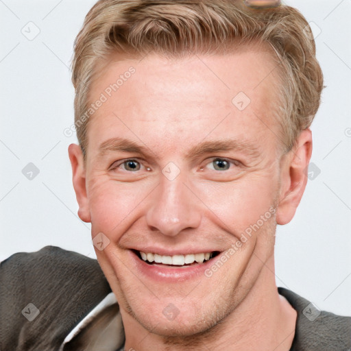 Joyful white adult male with short  brown hair and grey eyes