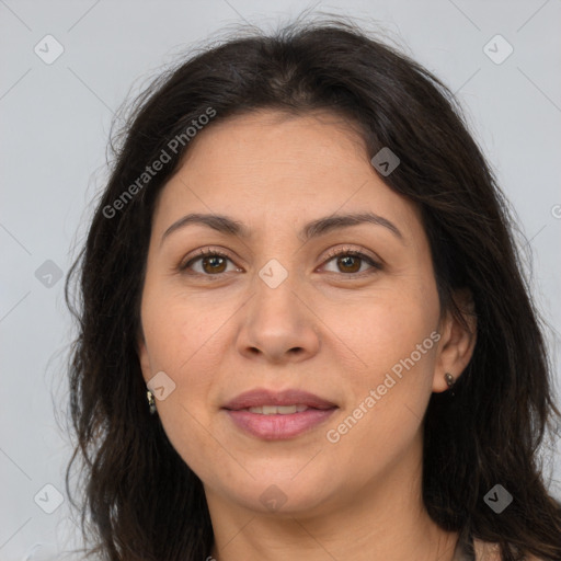 Joyful white adult female with long  brown hair and brown eyes